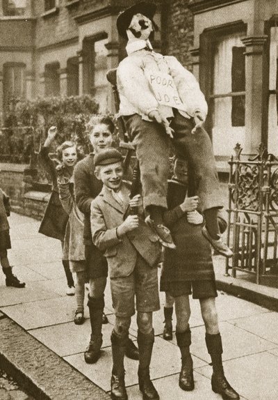 Children carrying a Guy Fawkes on Bonfire Night by English Photographer